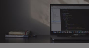 laptop computer screen with code - ACBM Blog - Making Sense of Logic Extensions in Orchestrator