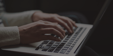 hands typing on a laptop - ACBM blog image - The Bright and Promising Future of JDE as a Modern ERP: Part 2