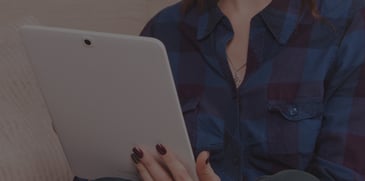 women reading a ACBM's blog on her tablet