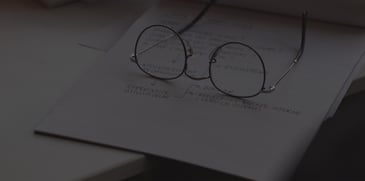 Glasses sitting on notebook - ACBM blog