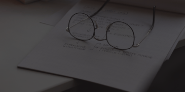 Glasses sitting on notebook - ACBM blog